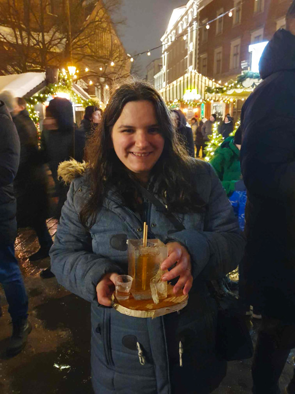Drinking out of an ice block at the Riga Christmas markets, Riga, Latvia